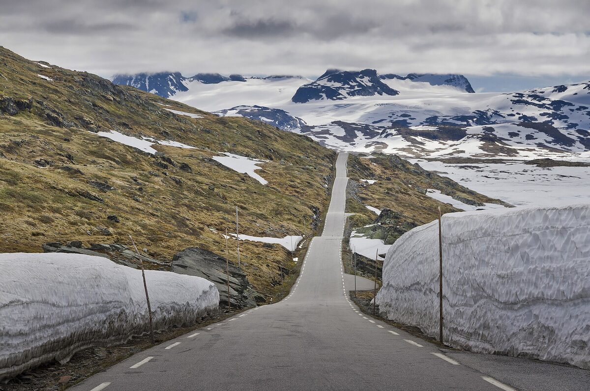 Fv55 road between melting snow walls at Sognefjellet, Norway