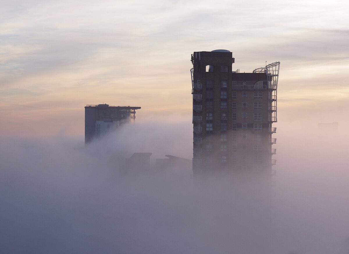 London tower blocks rising out of a fog sea at dawn